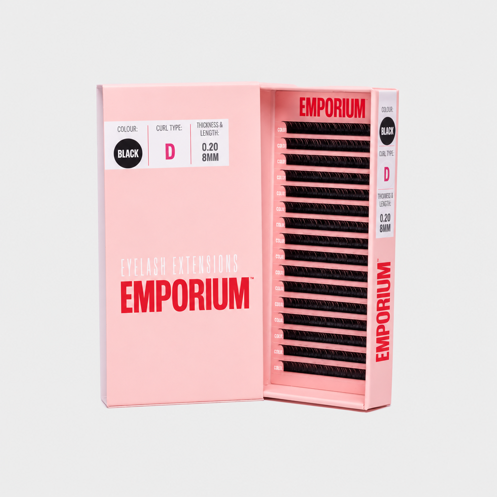A pink Emporium hair extension box shown open, revealing rows of black textured hair extensions inside. The box is labeled 'Emotion Extensions' and 'Emporium' with 'Black' and size 'C' visible on the packaging.